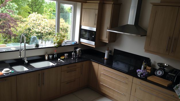 New kitchen fitted, including a double basing sink set within black granite worktops